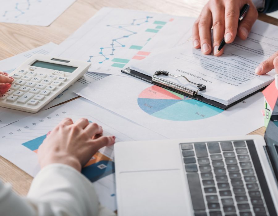 partial-view-of-man-studying-loan-agreement-and-businesswoman-using-calculator-while-sitting-at-q2h19wv190vwt07ryqojeqh2ti90wjp812mhs5fz2w partial-view-of-man-studying-loan-agreement-and-businesswoman-using-calculator-while-sitting-at-q2h19wv190vwt07ryqojeqh2ti90wjp812mhs5fz2w